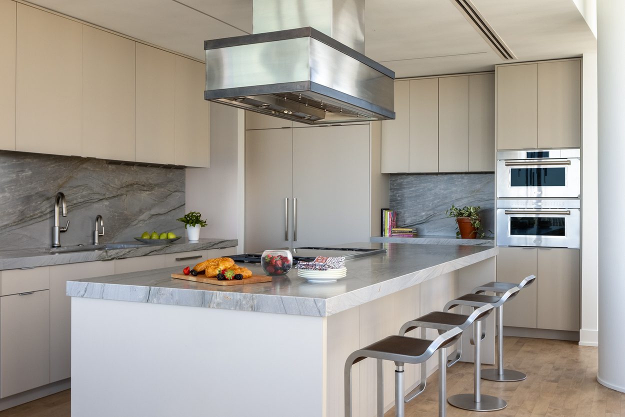Modern kitchen with island and bar stools.